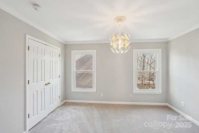 empty room with ornamental molding, light carpet, baseboards, and an inviting chandelier