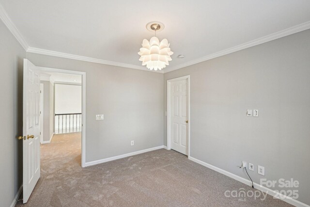 unfurnished room featuring light carpet, crown molding, and baseboards