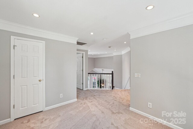 unfurnished room featuring recessed lighting, light carpet, crown molding, and visible vents