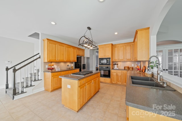 kitchen with dark countertops, a kitchen island, a sink, black appliances, and backsplash