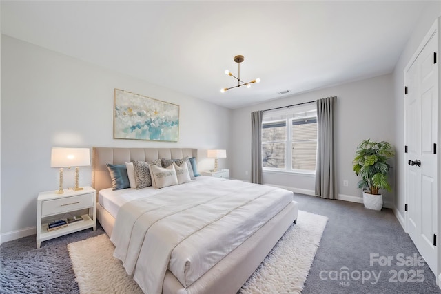 carpeted bedroom featuring baseboards, visible vents, and an inviting chandelier