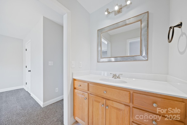 bathroom with vanity and baseboards