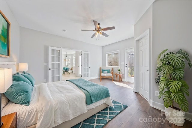 bedroom with wood-type flooring, baseboards, ceiling fan, and french doors