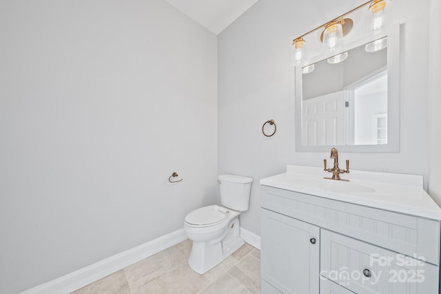 half bath featuring tile patterned floors, vanity, toilet, and baseboards