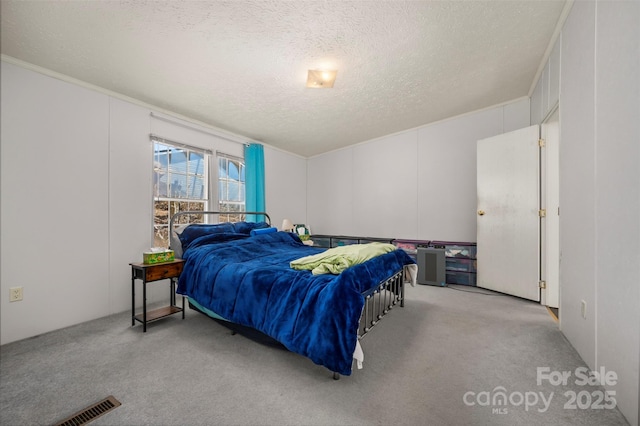 carpeted bedroom with visible vents and a textured ceiling