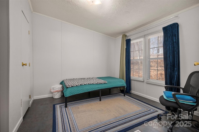 bedroom featuring a textured ceiling and crown molding