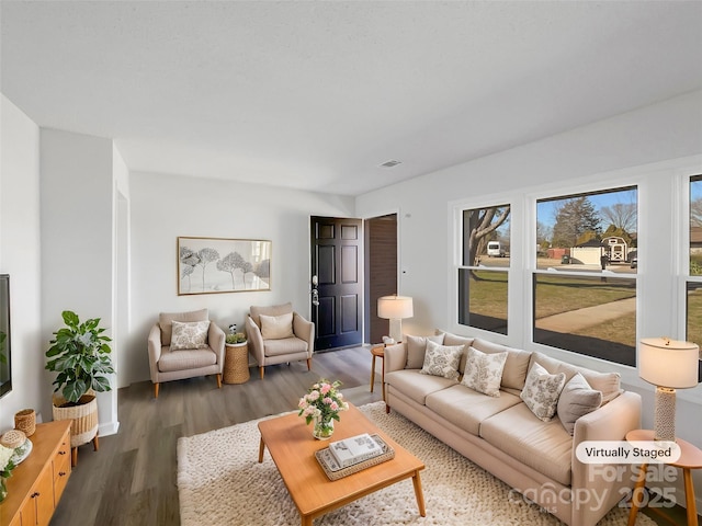 living room with dark wood finished floors and visible vents