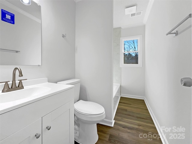 full bathroom with toilet, wood finished floors, visible vents, vanity, and baseboards