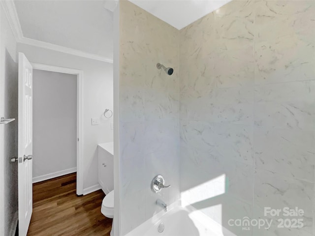 bathroom featuring shower / bath combination, toilet, vanity, wood finished floors, and baseboards