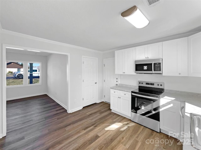 kitchen with baseboards, dark wood finished floors, stainless steel appliances, crown molding, and white cabinetry