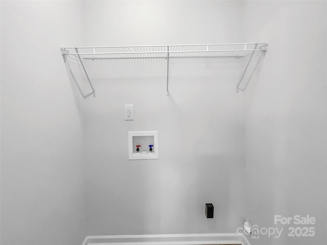 clothes washing area featuring washer hookup, laundry area, and baseboards