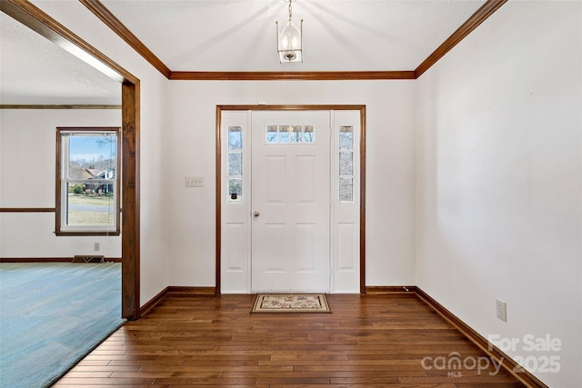 foyer entrance featuring dark wood-style floors, baseboards, visible vents, and crown molding