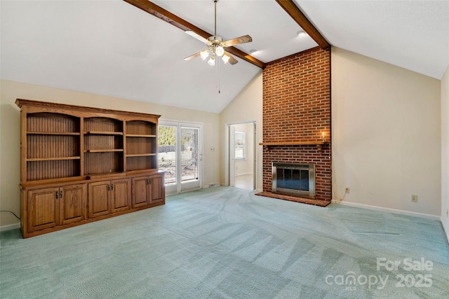 unfurnished living room with baseboards, a ceiling fan, light colored carpet, a brick fireplace, and beam ceiling