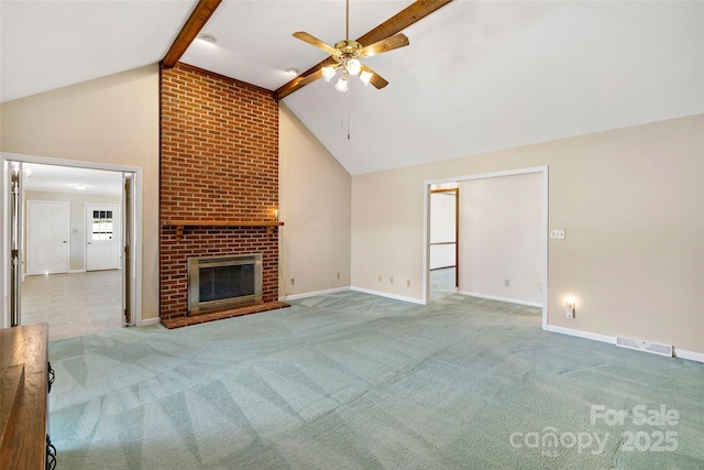 unfurnished living room featuring carpet floors, a brick fireplace, visible vents, and beamed ceiling