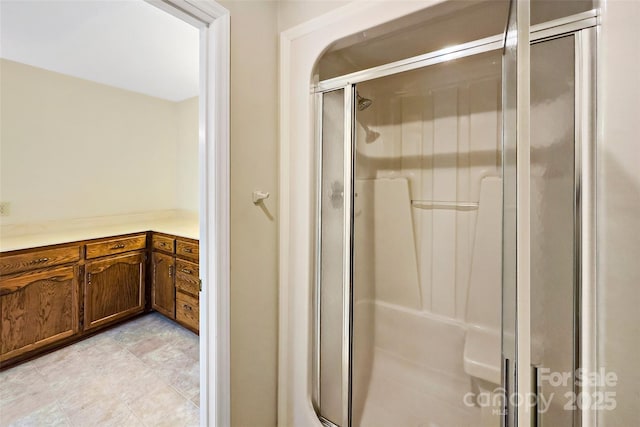 full bath with a shower stall and vanity