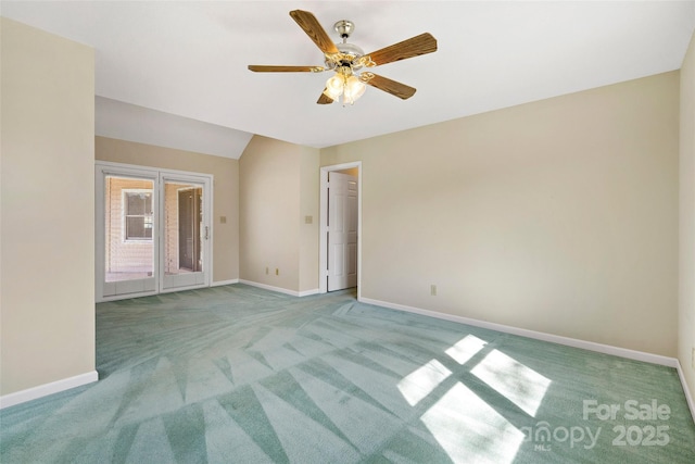 carpeted empty room featuring ceiling fan and baseboards