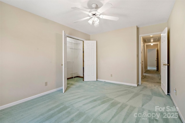 unfurnished bedroom with light colored carpet, ceiling fan, and baseboards