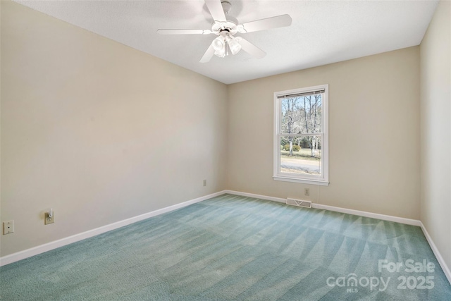 unfurnished room featuring baseboards, visible vents, ceiling fan, and carpet flooring