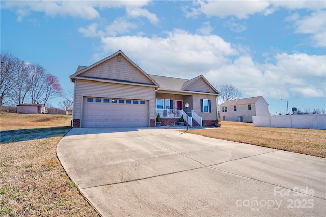 view of front of property with a porch, concrete driveway, an attached garage, and a front lawn