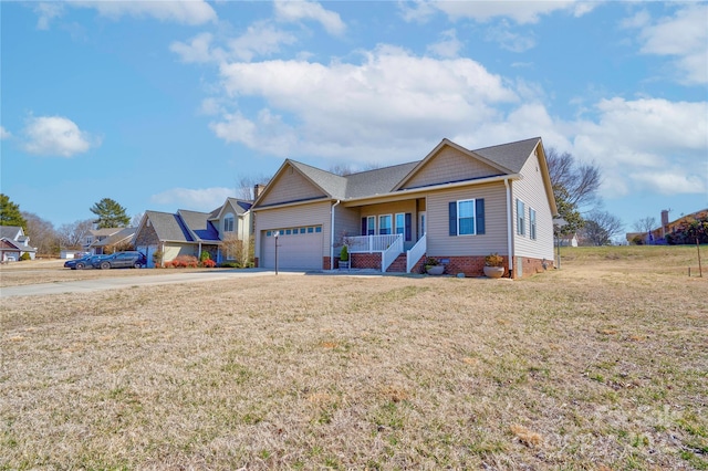 ranch-style home featuring covered porch, a front yard, crawl space, a garage, and driveway