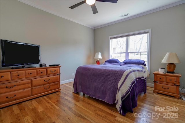 bedroom with baseboards, visible vents, ceiling fan, crown molding, and light wood-type flooring