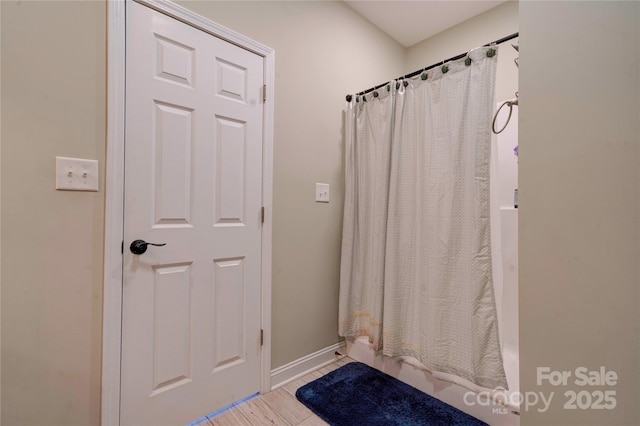 bathroom featuring baseboards and wood finished floors