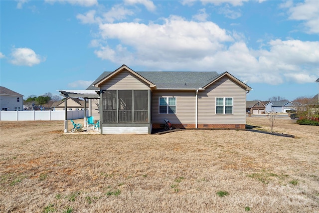 rear view of house featuring a sunroom, crawl space, fence, a yard, and a pergola