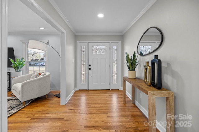 entrance foyer with ornamental molding, light wood-type flooring, baseboards, and recessed lighting