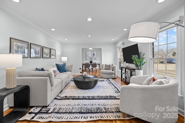 living room with baseboards, ornamental molding, wood finished floors, and recessed lighting