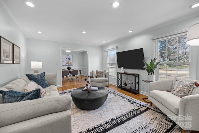 living area featuring ornamental molding, wood finished floors, and recessed lighting