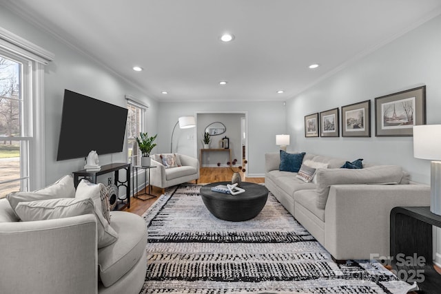 living room featuring baseboards, recessed lighting, wood finished floors, and crown molding