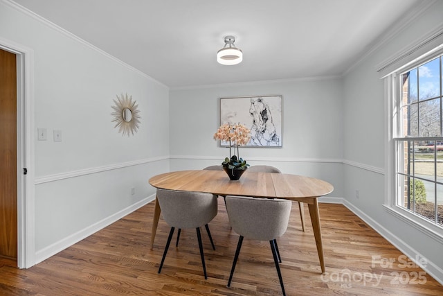 dining space with plenty of natural light, wood finished floors, and crown molding