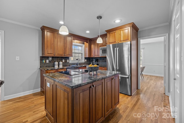 kitchen with stainless steel appliances, brown cabinetry, decorative backsplash, and crown molding