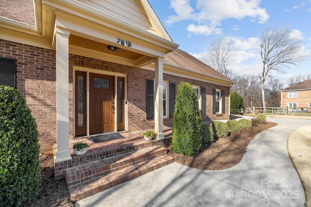 entrance to property with brick siding