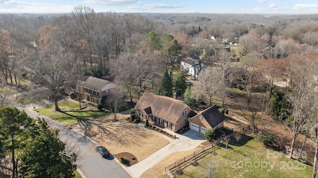 birds eye view of property featuring a forest view