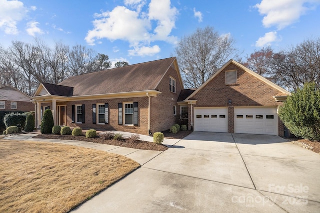 view of front of home featuring driveway, brick siding, and an attached garage