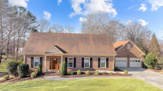 cape cod home with a garage, brick siding, concrete driveway, roof with shingles, and a front yard