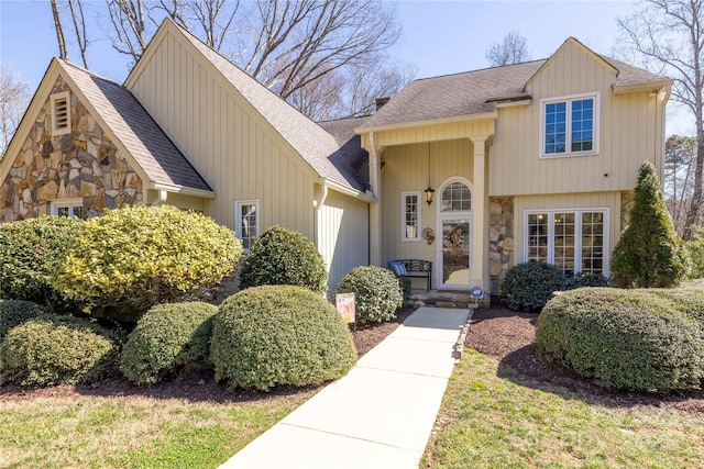 view of front of home featuring stone siding and a shingled roof