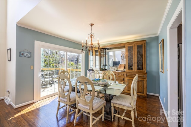 dining area featuring baseboards, dark wood finished floors, and crown molding