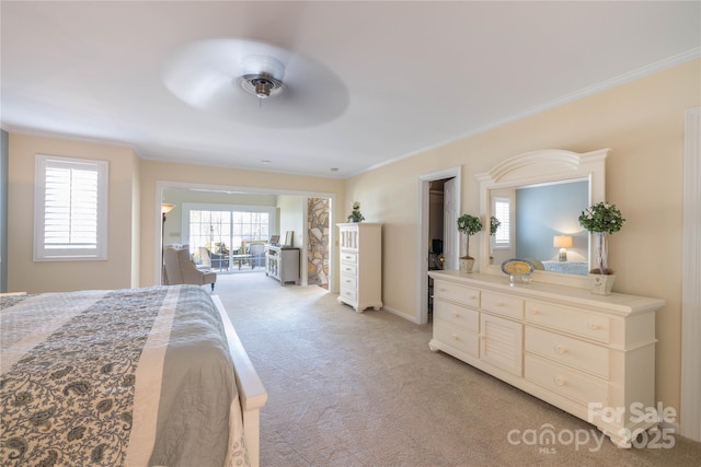 bedroom featuring ornamental molding, light colored carpet, and ceiling fan