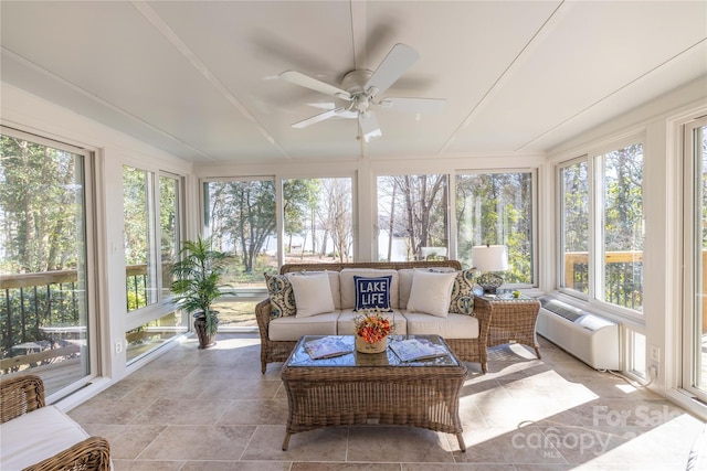 sunroom featuring a ceiling fan and a wall mounted air conditioner