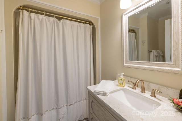 full bath with ornamental molding and vanity