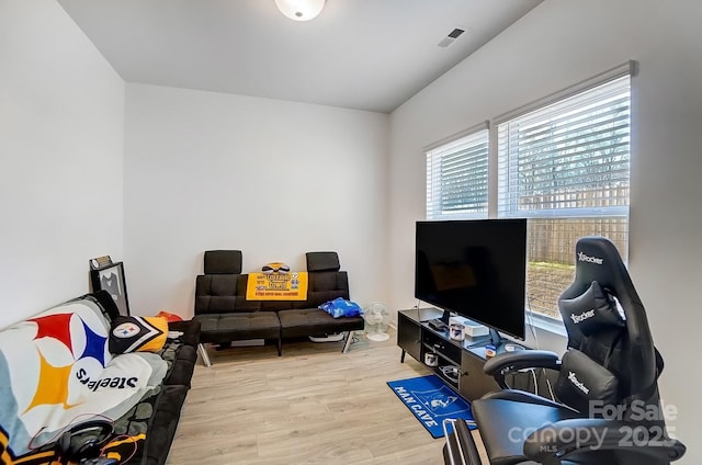 living room with wood finished floors and visible vents