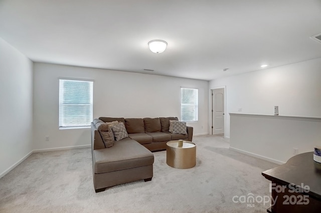 carpeted living room featuring visible vents and baseboards