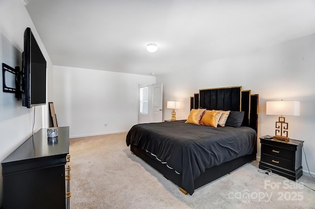 bedroom featuring light carpet and baseboards