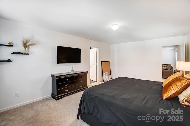 bedroom with baseboards and light colored carpet