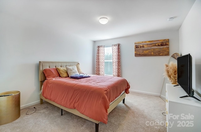 bedroom with light carpet and baseboards