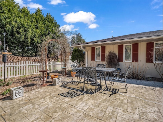 view of patio / terrace featuring outdoor dining area and fence