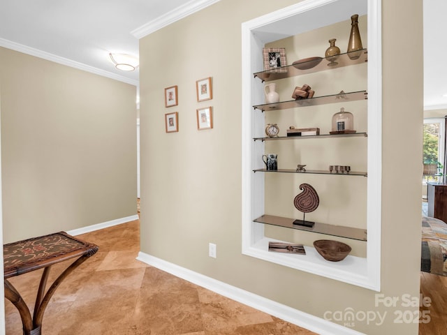 hall featuring baseboards and ornamental molding