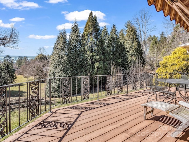 wooden terrace featuring outdoor dining area